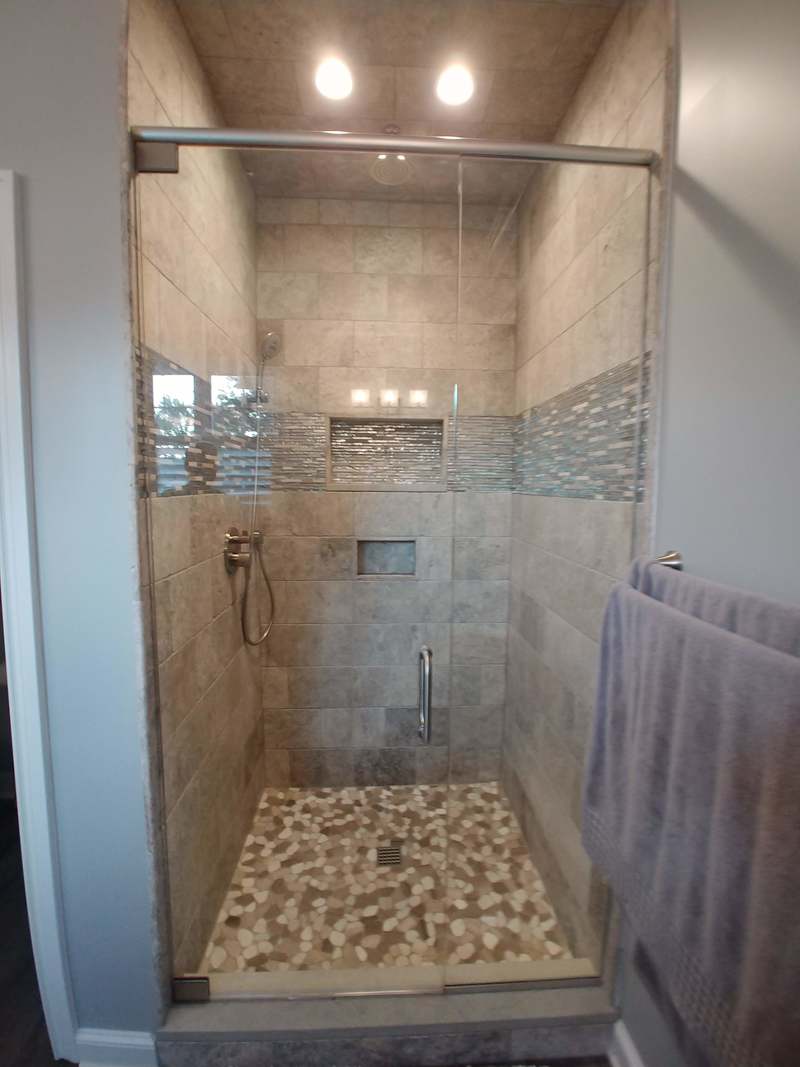 Walk in shower with silver travertine, USG shower system. 