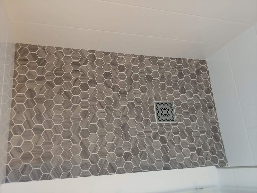 wood grain hexagon mosaic tile, shower pan.